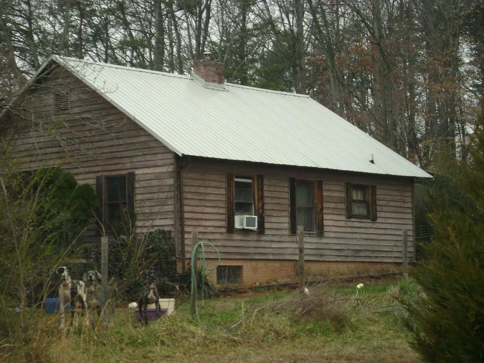 White metal roof on an old wood sided farmhouse, from a Metal Roof Installation job in Wishram